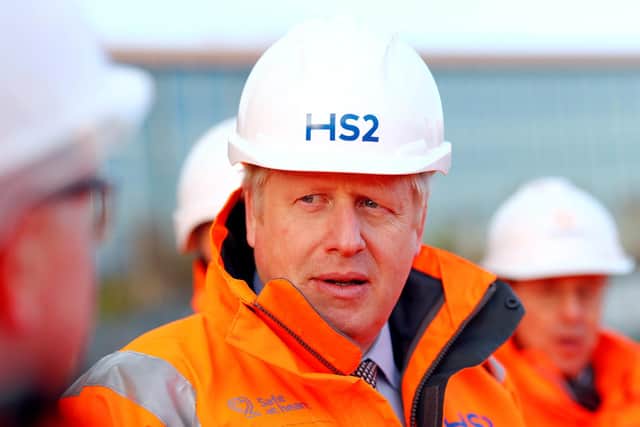 Boris Johnson listens during a visit to Curzon Street railway station where the HS2 rail project is under construction (Getty Images)