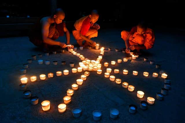 Buddhist monks light candles during Guru Purnima festival celebrations at the Maha Bodhi Society in Bangalore (Picture: Getty Images)
