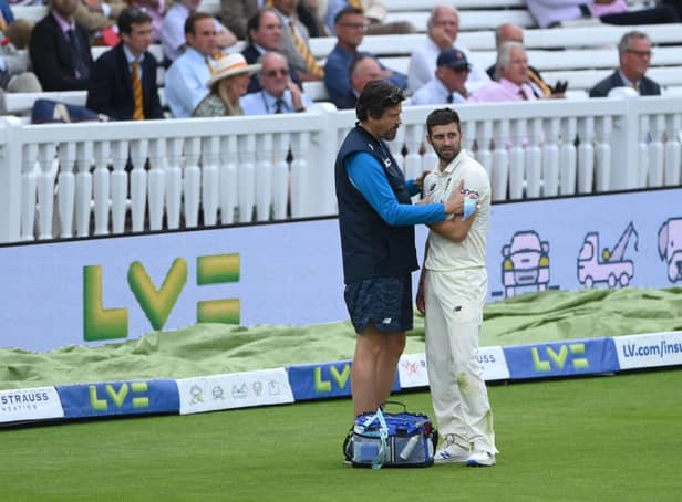 LONDON, ENGLAND - AUGUST 15: England bowler Mark Wood injures his shoulder after attempting to save a boundary during day four of the Second Test Match between England and India at Lord's Cricket Ground on August 15, 2021 in London, England. (Photo by Stu Forster/Getty Images)