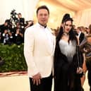 Elon Musk with his girlfriend Grimes. (Photo by Jason Kempin/Getty Images)