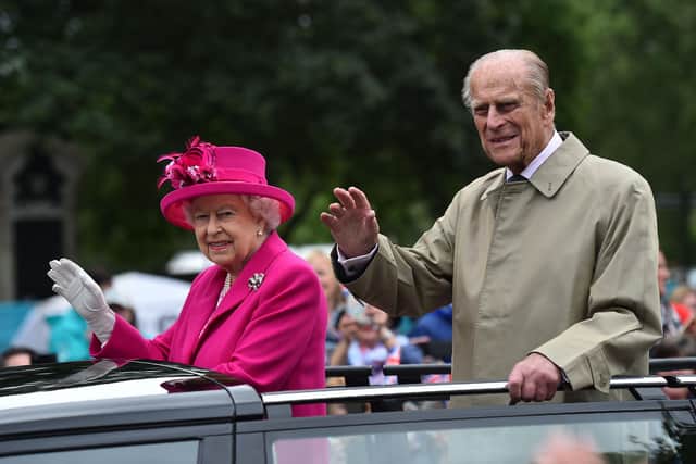The Queen and Prince Philip pictured waving to guests at a street party outside Buckingham Palace in 2016, as part of Queen Elizabeth II's official 90th birthday celebrations (Getty).