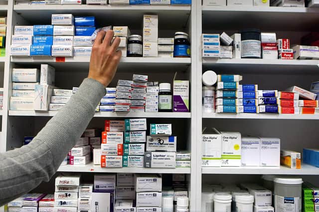 A pharmacist stocks shelves at a chemist. (Picture: Julien Behal/PA Wire)