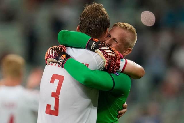 Denmark's goalkeeper Kasper Schmeichel celebrates with defender Jannik Vestergaard. (Photo by DARKO VOJINOVIC/POOL/AFP via Getty Images)