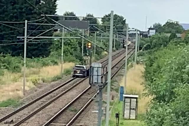 Watch: Commuters left in shock as stolen car drives down railway tracks fleeing police (Photo: SWNS)