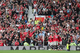Fans celebrate the fourth goal scored by Bruno Fernandes of Manchester United and his hat-trick during the Premier League match between Manchester United and Leeds United at Old Trafford. (Photo by Alex Morton/Getty Images)