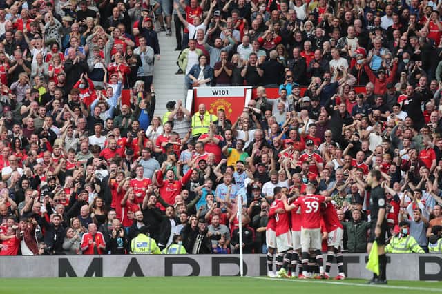Fans celebrate the fourth goal scored by Bruno Fernandes of Manchester United and his hat-trick during the Premier League match between Manchester United and Leeds United at Old Trafford. (Photo by Alex Morton/Getty Images)