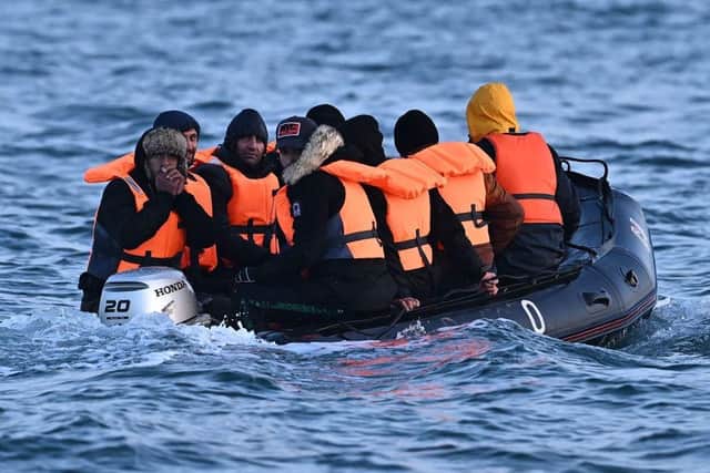 Migrants travel in an inflatable boat across the English Channel, bound for Dover on the south coast of England. More than 45,000 migrants arrived in the UK last year by crossing the English Channel on small boats.
