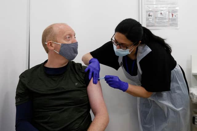 Martin Gillibrand, 45, receives an AstraZeneca vaccination at a Boots pharmacy on Fleet Street in the City of London.