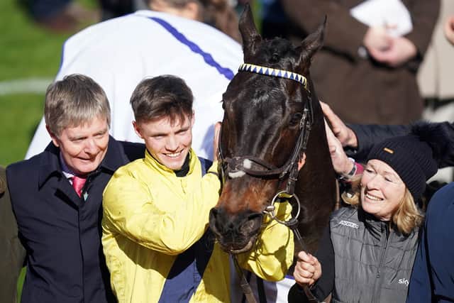 Michael O'Sullivan celebrates winning the Sky Bet Supreme Novices' Hurdle with Marine Nationale, alongside owner and trainer Barry Connell (left) on day one of the Cheltenham Festival.