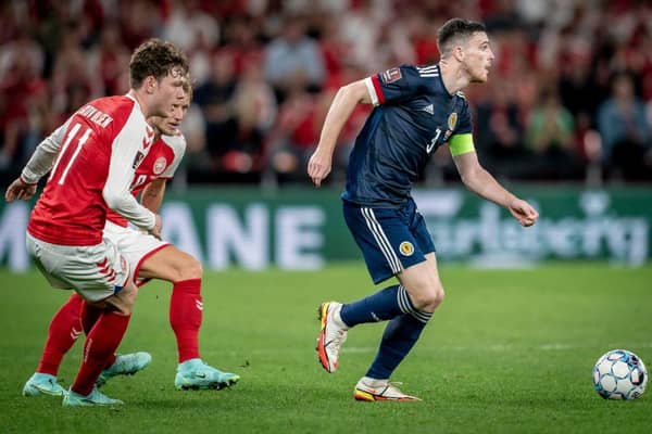 Scotland's Andy Robertson (R) runs with at the ball during the FIFA World Cup Qatar 2022 qualification football match between Denmark and Scotland in Copenhagen (Photo by MADS CLAUS RASMUSSEN/Ritzau Scanpix/AFP via Getty Images)