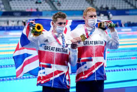 Great Britain's Tom Dean (right) with his gold medal after winning the Men's 200m Freestyle Final alongside Great Britain's Duncan Scott with his silver medal at the Tokyo Aquatics Centre on the fourth day of the Tokyo 2020 Olympic Games in Japan (PA)