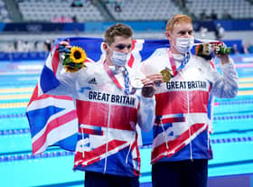 Great Britain's Tom Dean (right) with his gold medal after winning the Men's 200m Freestyle Final alongside Great Britain's Duncan Scott with his silver medal at the Tokyo Aquatics Centre on the fourth day of the Tokyo 2020 Olympic Games in Japan (PA)