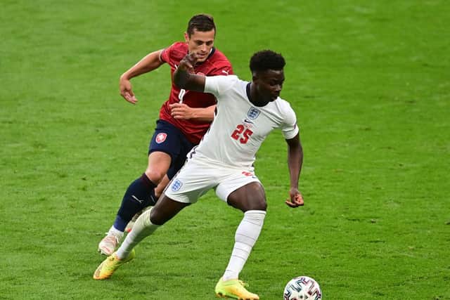 Bukayo Saka of England runs with the ball whilst under pressure from Tomas Holes of Czech Republic.