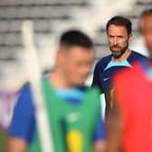 England's coach Gareth Southgate (C) watches his players during a training session at Al Wakrah SC Stadium in Al Wakrah, south of Doha on November 26, 2022, during the Qatar 2022 World Cup football tournament. (Photo by Adrian DENNIS / AFP) (Photo by ADRIAN DENNIS/AFP via Getty Images)