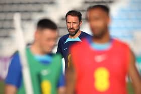 England's coach Gareth Southgate (C) watches his players during a training session at Al Wakrah SC Stadium in Al Wakrah, south of Doha on November 26, 2022, during the Qatar 2022 World Cup football tournament. (Photo by Adrian DENNIS / AFP) (Photo by ADRIAN DENNIS/AFP via Getty Images)