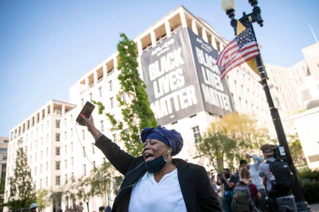 A person celebrates the verdict of the Derek Chauvin trial at Black Lives Matter Plaza near the White House on April 20, 2021 in Washington, D.C. (Photo by Sarah Silbiger/Getty Images)