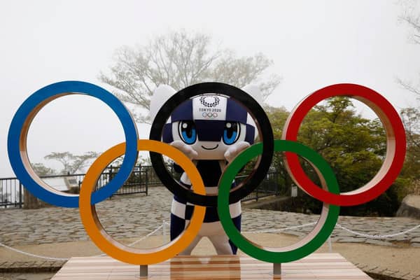 Tokyo 2020 Olympic Games mascot Miraitowa poses with the Olympic Symbol.