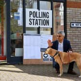 London Mayor Sadiq Khan waves to voters as he poses with his dog Luna on his arrival at a polling station in London (Justin Tallis / AFP) (Photo by JUSTIN TALLIS/AFP via Getty Images)