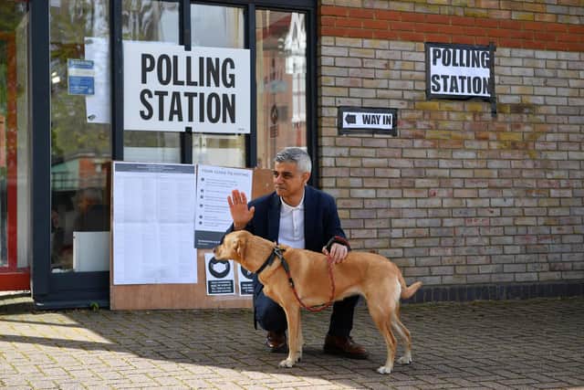 London Mayor Sadiq Khan waves to voters as he poses with his dog Luna on his arrival at a polling station in London (Justin Tallis / AFP) (Photo by JUSTIN TALLIS/AFP via Getty Images)