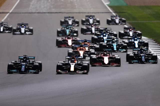 Lewis Hamilton and Max Verstappen lead the field into turn one at the start during the F1 Grand Prix of Great Britain at Silverstone. (Photo by Lars Baron/Getty Images)