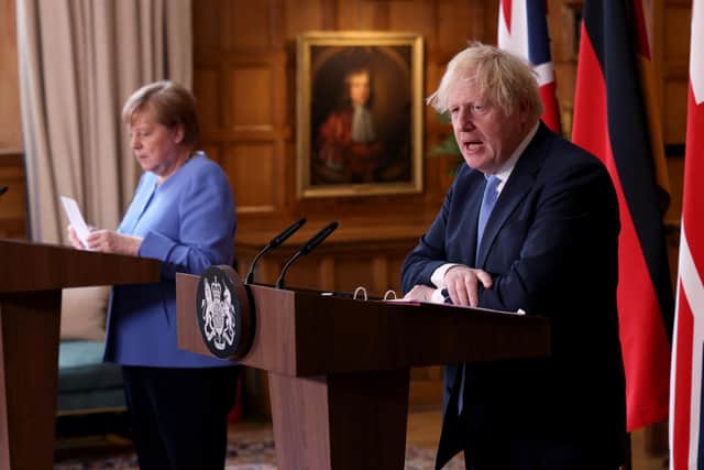 Prime Minister Boris Johnson and the Chancellor of Germany, Angela Merkel, during a press conference after their meeting at Chequers (PA)