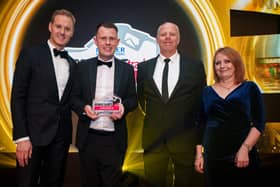 SPAR Mallusk FTA: Daniel Mellor from SPAR Mallusk accepts the award for Best NI Forecourt (up to 4mlpa) from Brooker’s Simon Cloke (left). Also pictured is Awards host, Dan Walker