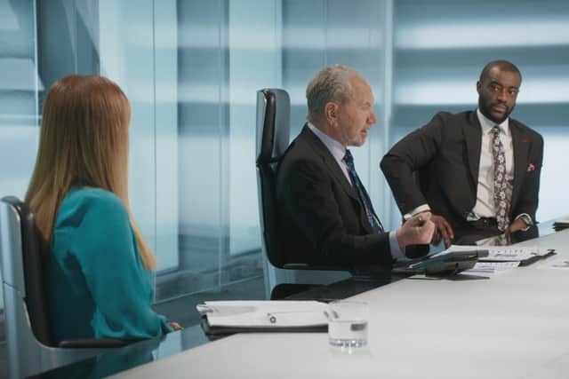 Lord Sugar talks to the candidates in the boardroom