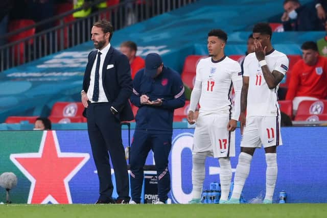 Jadon Sancho and Marcus Rashford of England wait to be substituted on next to Gareth Southgate, Head Coach of England during the UEFA Euro 2020 Championship Final. (Photo by Laurence Griffiths/Getty Images)