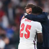Bukayo Saka of England is consoled by Gareth Southgate, Head Coach of England, following defeat in the UEFA Euro 2020 Championship Final.
