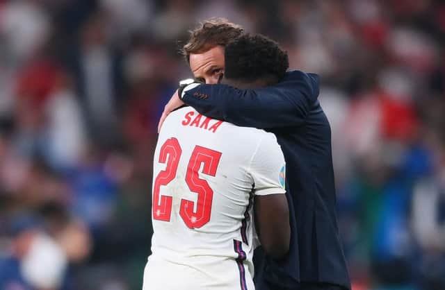 Bukayo Saka of England is consoled by Gareth Southgate, Head Coach of England, following defeat in the UEFA Euro 2020 Championship Final.