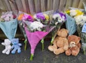 Teddy bears and flowers left at the scene of the triple murder at Petherton Court, Kettering