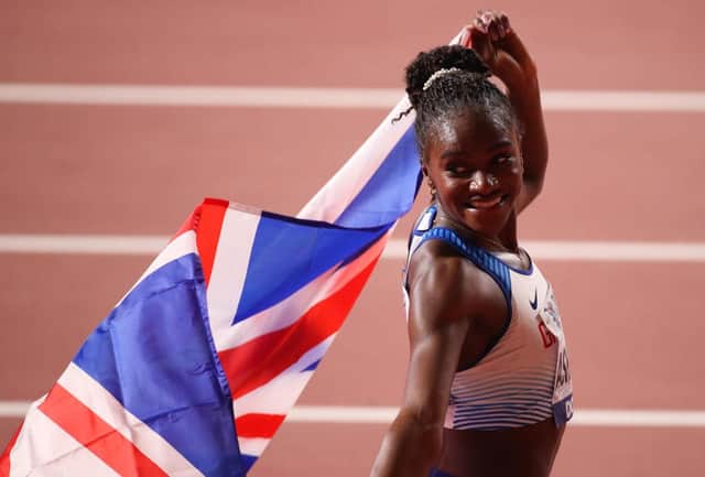 Dina Asher-Smith of Great Britain celebrates after winning gold in the Women's 200 metres final at the World Athletics Championships Doha 2019.