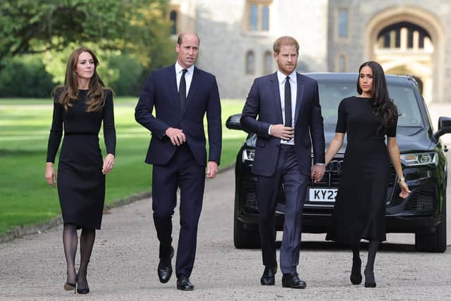 Prince Harry, Duke of Sussex (second from right) holds hands with Meghan, Duchess of Sussex on the long Walk at Windsor Castle. They greeted well-wishers alongside Catherine, Princess of Wales, and Prince William, Prince of Wales. Picture: Chris Jackson/Getty Images