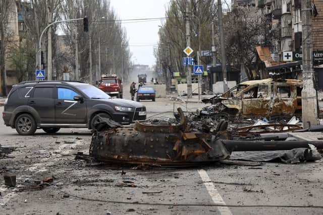 A part of a destroyed tank and a burned vehicle sit in an area controlled by Russian-backed separatist forces in Mariupol, Ukraine. (AP Photo/Alexei Alexandrov)