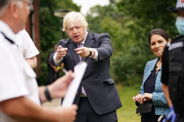 Boris Johnson and Home Secretary Priti Patel visit Surrey Police headquarters in Guildford, south west of London (Photo by Yui Mok / POOL / AFP)