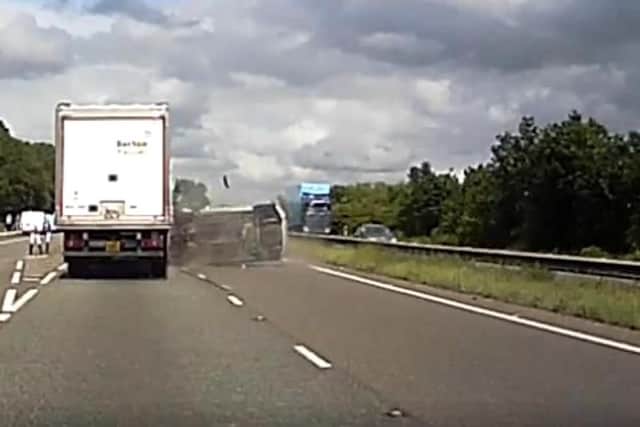 The video shows the driver swerving before crashing into the side of the lorry