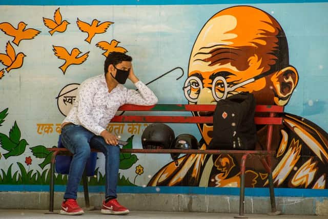 A man wearing a protective mask sits on a New Delhi bench, as India undergoes its first national lockdown in April 2020 (Photo: Yawar Nazir/Getty Images)
