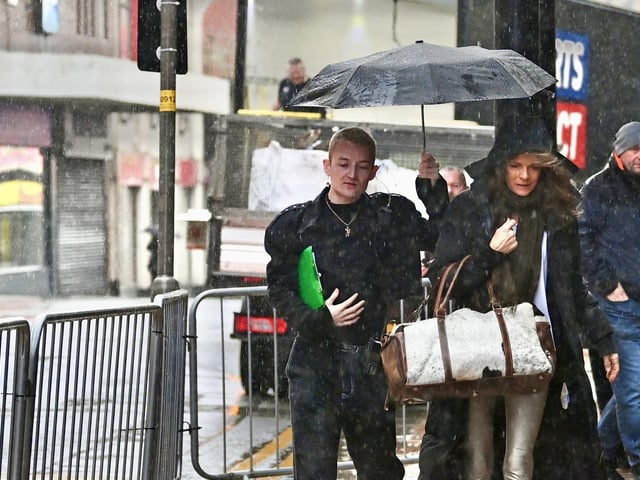 Tennis and TV star Annabel Croft gets a helping hand in the Lancashire rain.