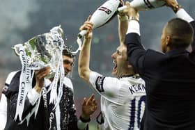 Juande Ramos is doused with champagne by Robbie Keane. (Photo by ADRIAN DENNIS/AFP via Getty Images)