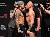 Dustin Poirier and Conor McGregor face off during the UFC 257 weigh-in.