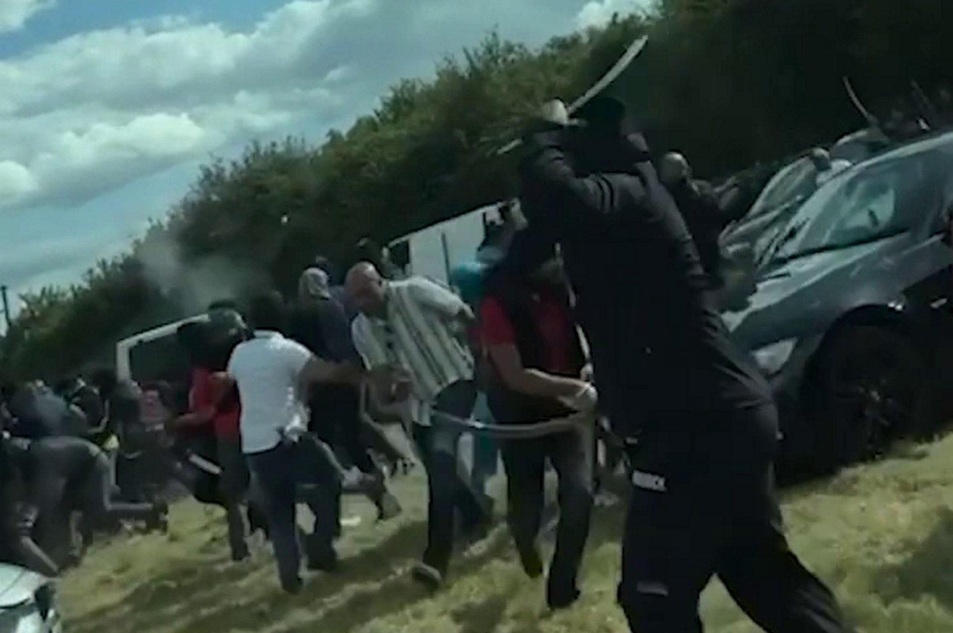 Shocking video shows moment shots are fired as men wield machetes, axes and bats in large-scale disorder