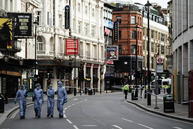 Forensics officers and police at the scene in Shaftesbury Avenue, central London, where two male police officers were stabbed by a man around 6am. Both officers are currently being treated by medics. The suspect was arrested on suspicion of causing grievous bodily harm and assaulting an emergency worker.