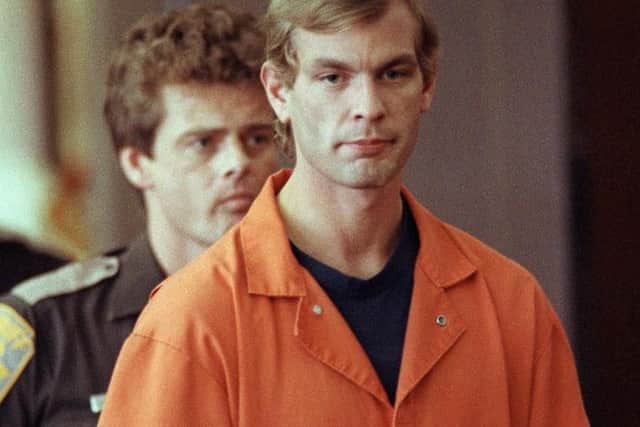 Serial killer Jeffrey L. Dahmer enters the courtroom of judge Jeffrey A. Wagner 06 August 1991. (Photo credit: EUGENE GARCIA/AFP via Getty Images)