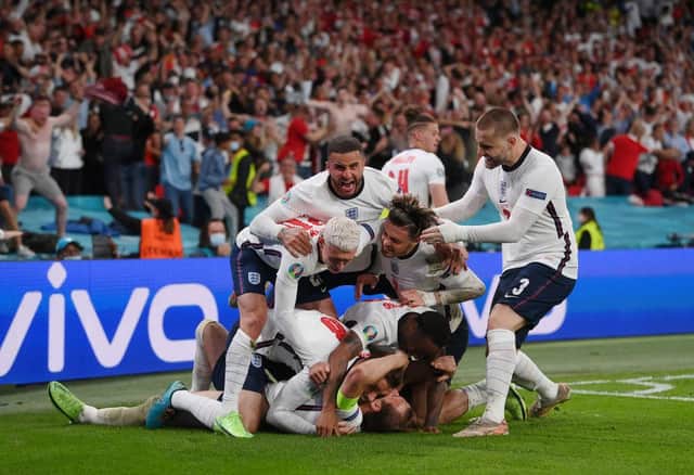 Harry Kane of England is congratulated after scoring his team's second goal by Jordan Henderson, Phil Foden, Kyle Walker, Jack Grealish, Raheem Sterling and Luke Shaw. (Photo by Laurence Griffiths/Getty Images)