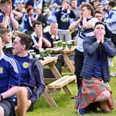 Scotland fans react as they watch their team crash out of Euro 2020 after defeat against Croatia.