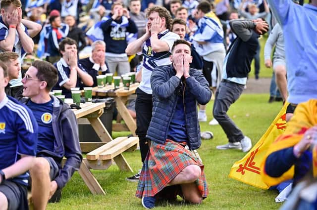 Scotland fans react as they watch their team crash out of Euro 2020 after defeat against Croatia.