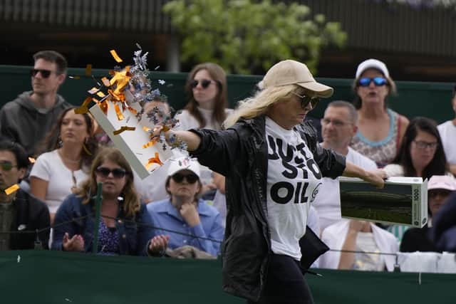 Play has been suspended on Court 18 at Wimbledon after two protesters ran on to the grass and threw orange confetti (Photo: Just Stop Oil)