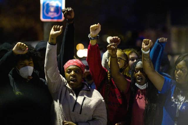 Demonstrators chant around a chalk circle that says Justice for Daunte Wright on April 11, 2021 in Brooklyn Center, Minnesota. Protesters took to the streets after 20 year old Daunte Wright was shot and killed during a traffic stop by members of the Brooklyn Center police.