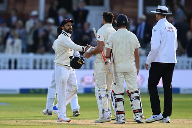LONDON, ENGLAND - AUGUST 16: Virat Kohli of India shakes hands with James Anderson and Mark Wood of England after winning the Second LV= Insurance Test Match between England and India  at Lord's Cricket Ground on August 16, 2021 in London, England. (Photo by Gareth Copley/Getty Images)