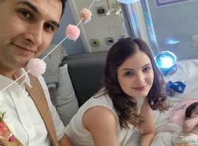 Karim Rezaie, 38, psychological therapist and Louise Rezaie, 30, psychological well-being practitioner pictured on their wedding day with their baby daughter Layla as the bridesmaid (SWNS).